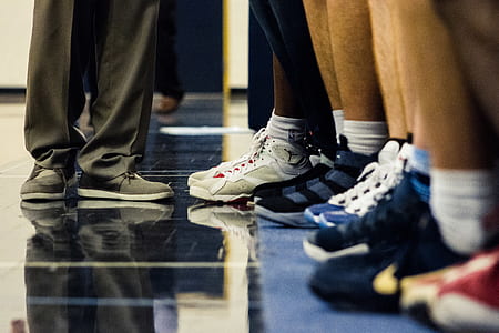 group of people standing on blue floor thumbnail