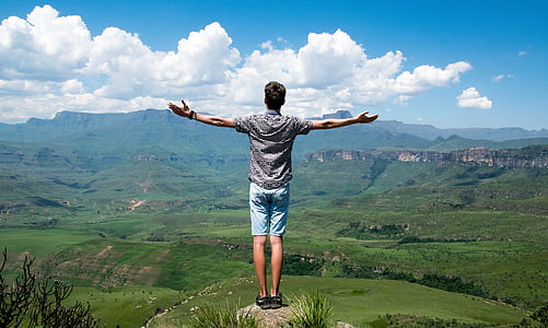 man in black shirt standing on cliff thumbnail