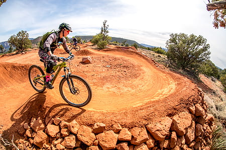 man driving mountain bike near cliff thumbnail