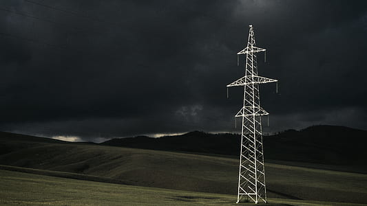 white electricity pylon under cloudy sky thumbnail