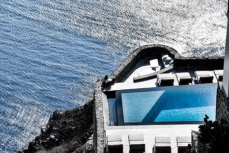 white and blue building near body of water during daytime thumbnail