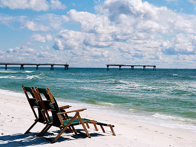 two green deck chairs beside beach thumbnail