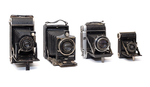 four black land cameras on white surface thumbnail