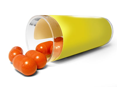 orange pills spilled on yellow glass container thumbnail