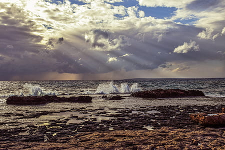 body of water near rock formation thumbnail