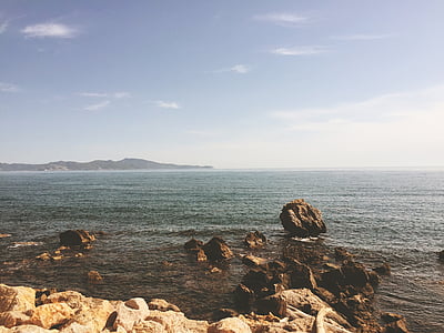 rocks on sea at daytime thumbnail