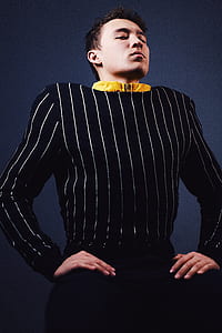 man in black and white pinstripe long-sleeved top thumbnail