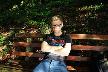 man sitting on bench during daytime thumbnail