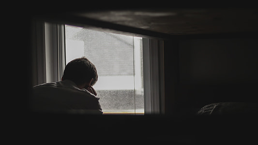 man thinking near window thumbnail