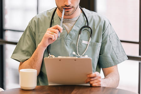 Doctor Looking At Clipboard Photo thumbnail