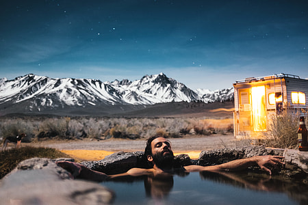 long exposure photography of man in hot spring thumbnail