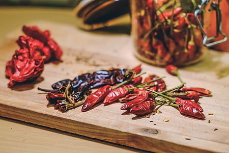 red chili on brown wooden chopping board thumbnail