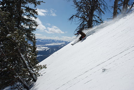 person sliding on a snow during daytime thumbnail