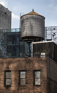 grey water tower on brown concrete building thumbnail