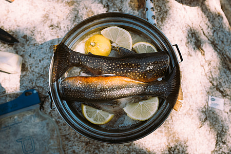 two black fish's tails with lemon in cooking pot thumbnail