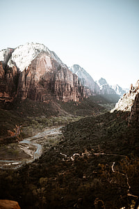 body of water in between rocky mountains during daytime photography thumbnail