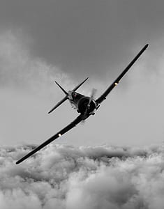 black aircraft on clouds thumbnail