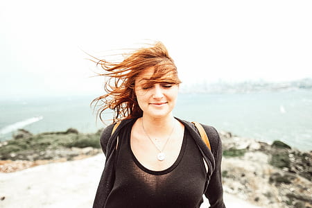 woman standing front of sea at daytime thumbnail