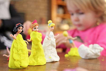 Selective Focus Photography of Three Disney Princesses Figurines on Brown Surface thumbnail