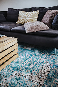 Designer living room interior with a wooden box table and a light blue carpet thumbnail