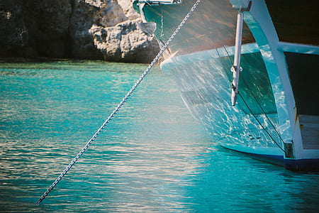 white and brown anchored boat thumbnail