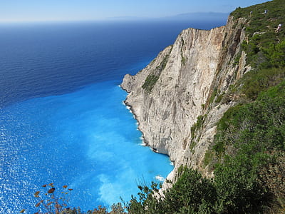 aerial photography of body of water beside cliff thumbnail