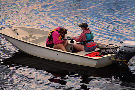 Two Women on Speedboat Sailing on Body of Water thumbnail