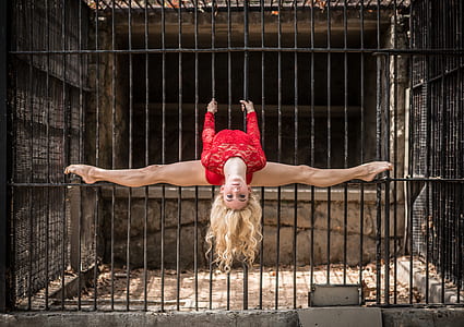 woman holding cage bars thumbnail