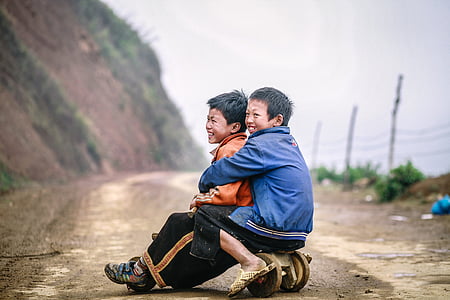 two boys sitting on wooden toy thumbnail