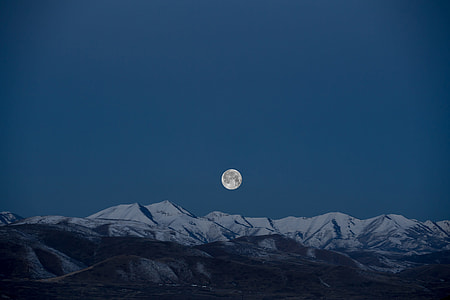 photo of full moon above snow-covered hills thumbnail