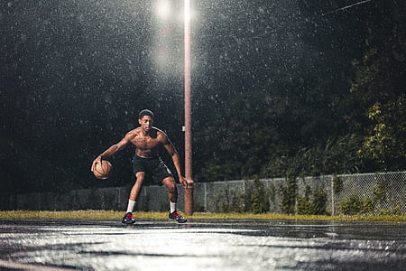 person playing basketball during nighttime thumbnail