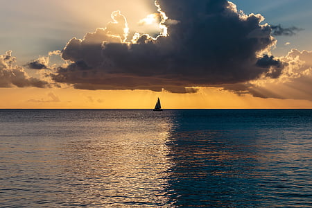 silhouette of boat on calm body of water thumbnail