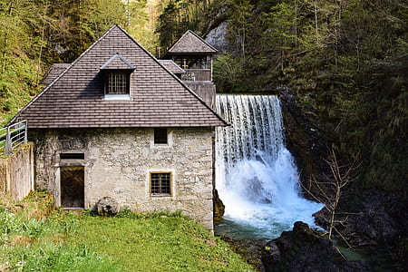 time lapse photography of plunge waterfalls near 2-storey house thumbnail