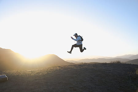 time lapse photo of man floating on air at daytime thumbnail