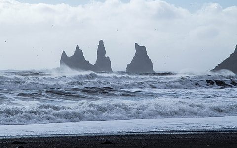 stone formation on sea during daytime thumbnail