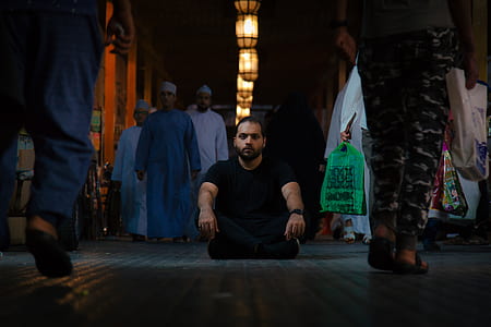 man sitting in middle of dark pathway thumbnail