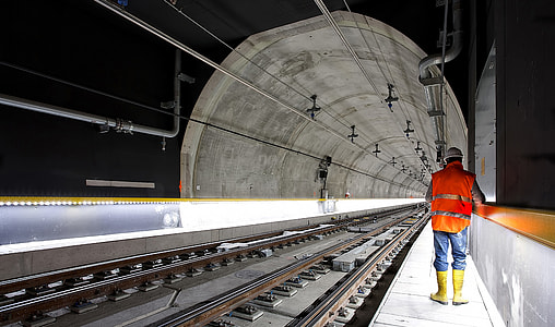 man walking near train rail thumbnail