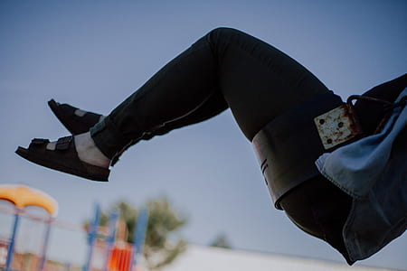 person riding in black swing during daytime thumbnail
