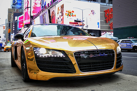 gold Audi R8 coupe parked near building thumbnail