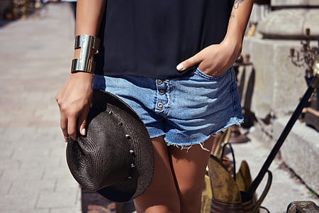 woman holding black hat while tucking its hand on pocket thumbnail