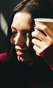 Woman Wearing Red Long-sleeved Shirt Holding Cup thumbnail