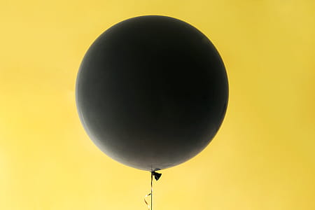 Black Balloon On Yellow Photo thumbnail