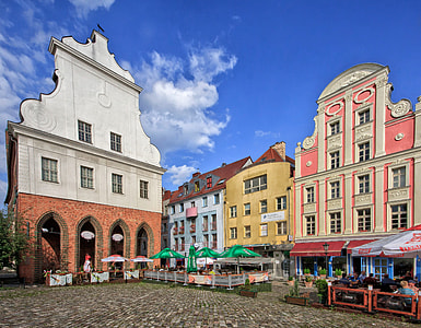 assorted-color painted buildings under cloudy sky thumbnail