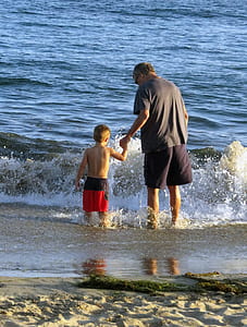 man and toddler on seashore thumbnail