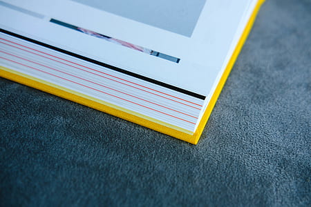 yellow handbound book on gray pad thumbnail