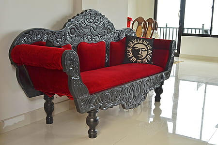 gray wooden frame red padded sofa with black sun throw pillow inside white painted room thumbnail