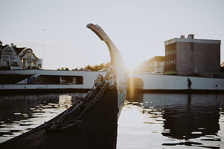 brown and white boat on body of water thumbnail