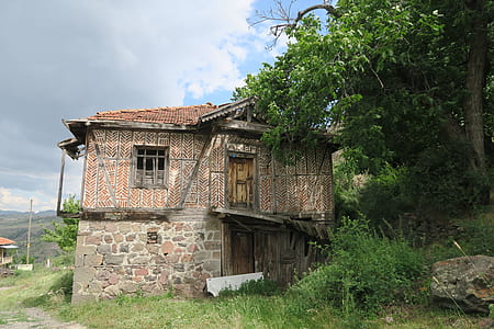 brown concrete house near trees thumbnail
