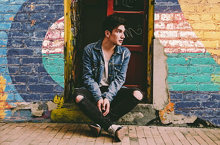 man sitting on doorway thumbnail