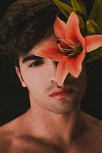 man behind orange flower thumbnail